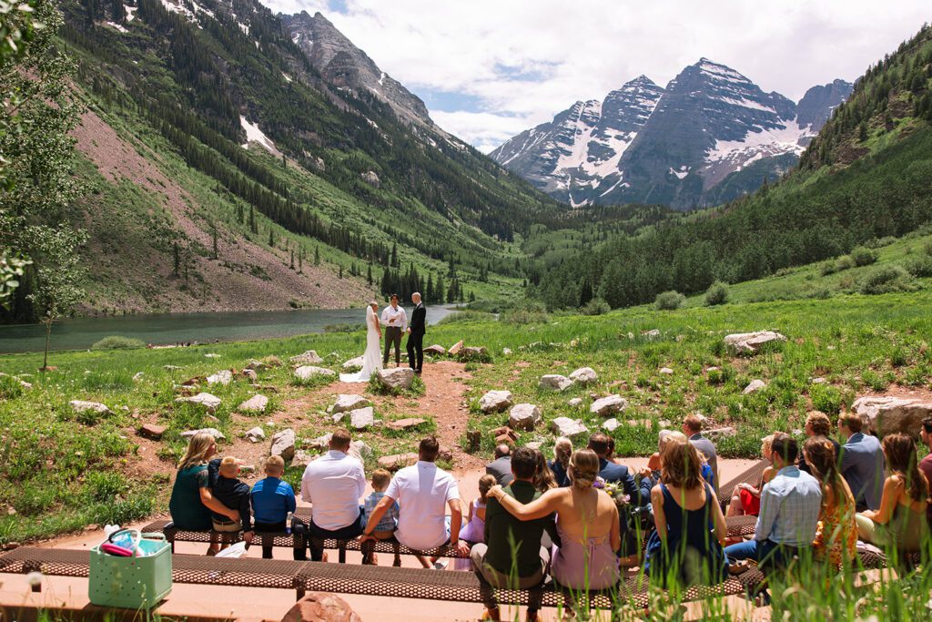Intimate Maroon Bells elopement ceremony with alpine mountains and reflection in the lake