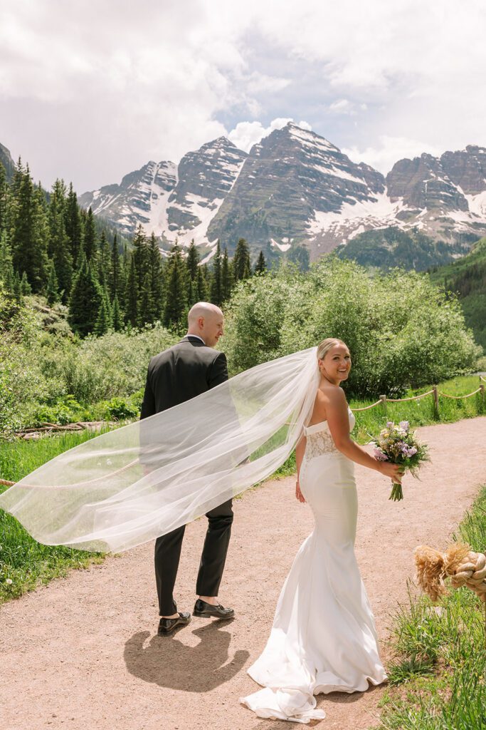Colorado mountain elopement at Maroon Bells with couple walking along the lakeshore