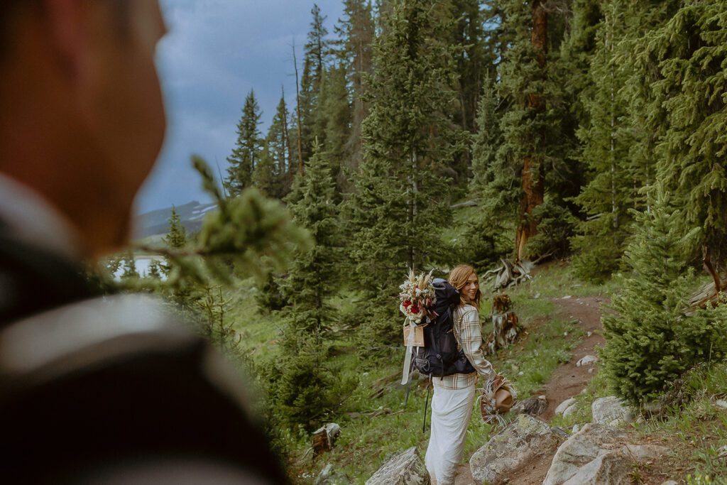 Bride and groom hiking during Colorado elopement