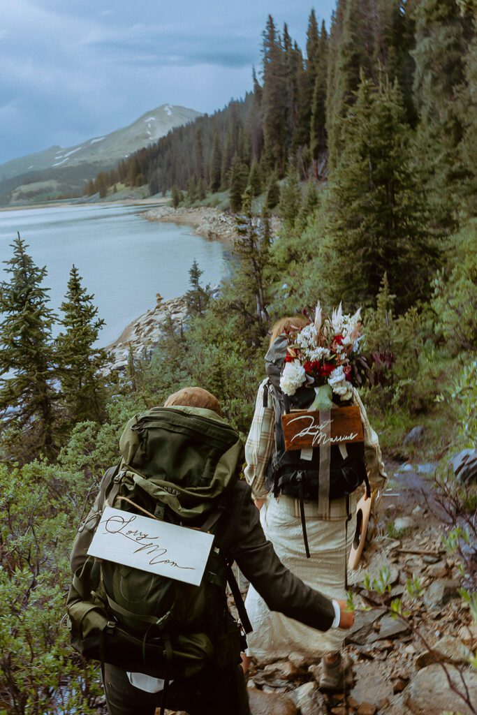 Couple hiking near alpine lake during elopement