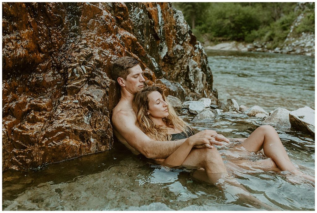 A couple laying down in the Idaho hot springs