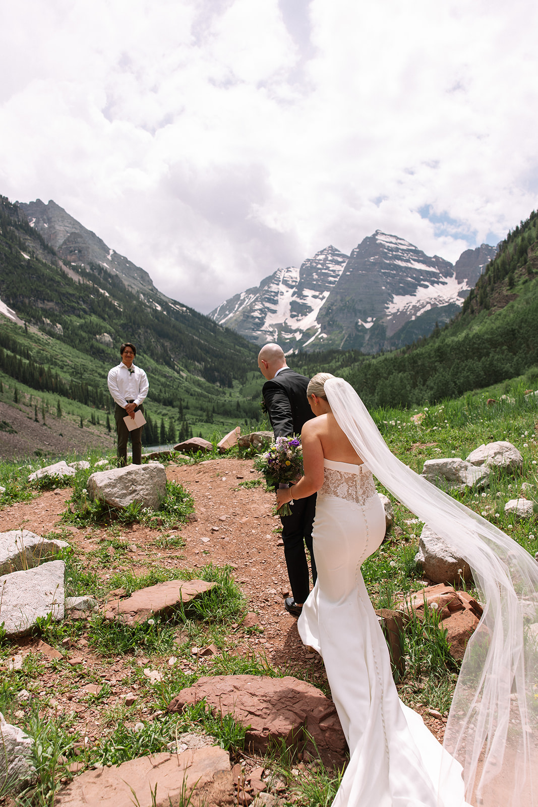 Colorado mountain elopement at Maroon Bells with couple walking along the lakeshore